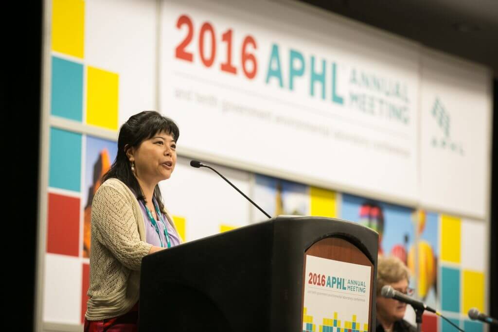 Lixia Liu, director of the New Mexico Department of Health Scientific Laboratory Division, welcomes attendees to Albuquerque