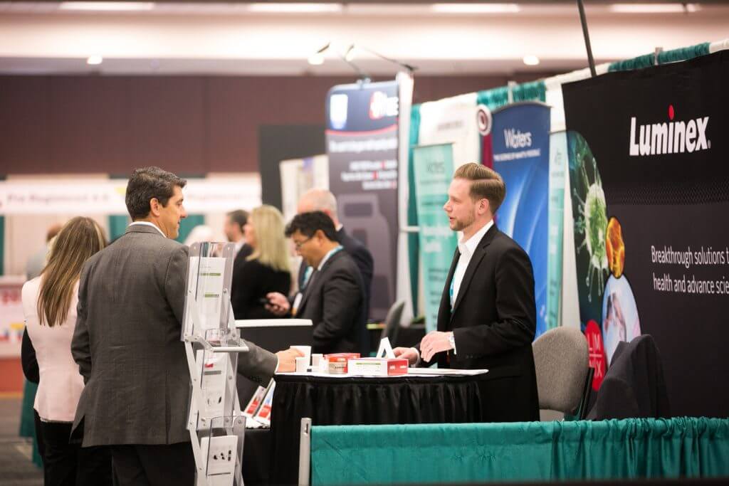 Meeting attendees visit exhibitors