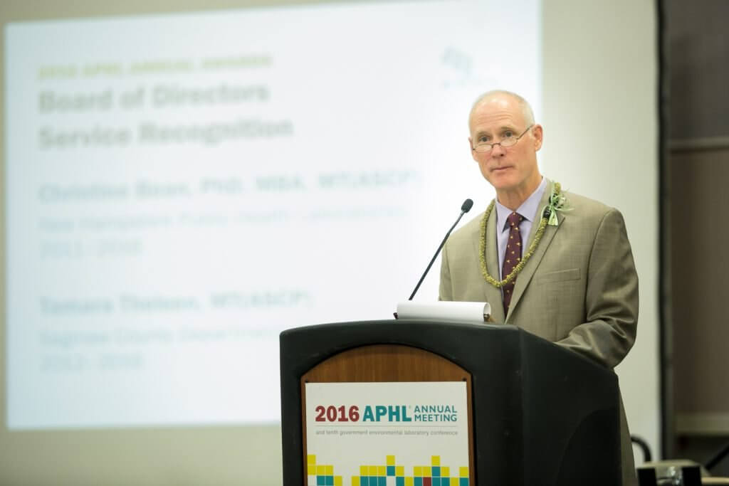 Chris Whelen, APHL board president, presents awards to out-going board members and committee chairs