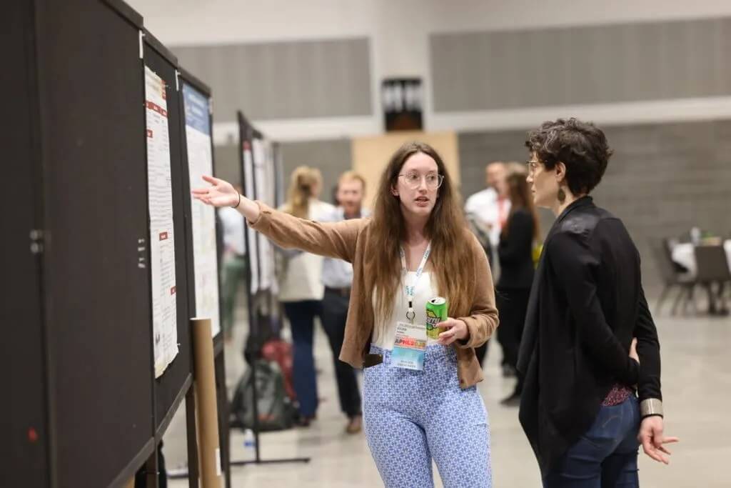 Two people view posters at the 2023 APHL Annual Conference