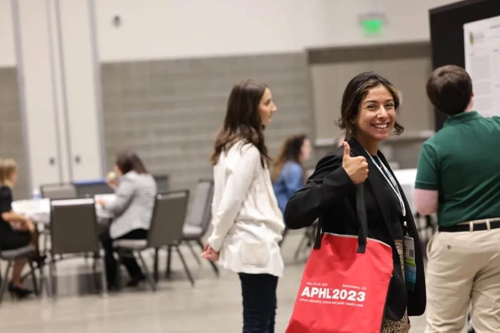 An APHL Annual Conference attendee gives a thumbs up