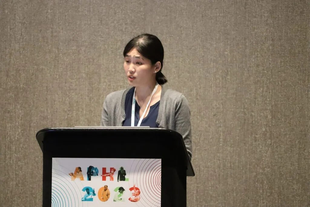 A speaker stands at a podium