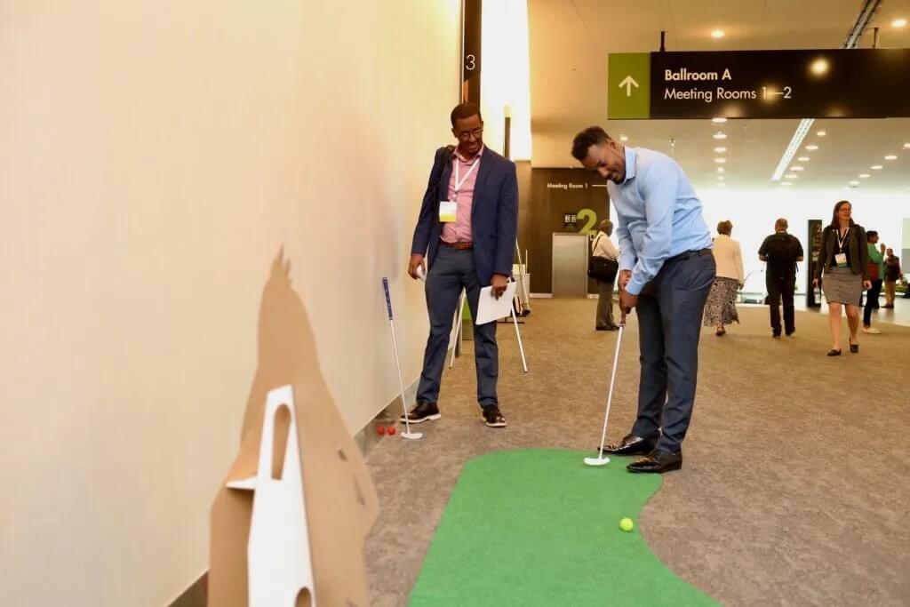 Attendees take a break between sessions to play mini golf.