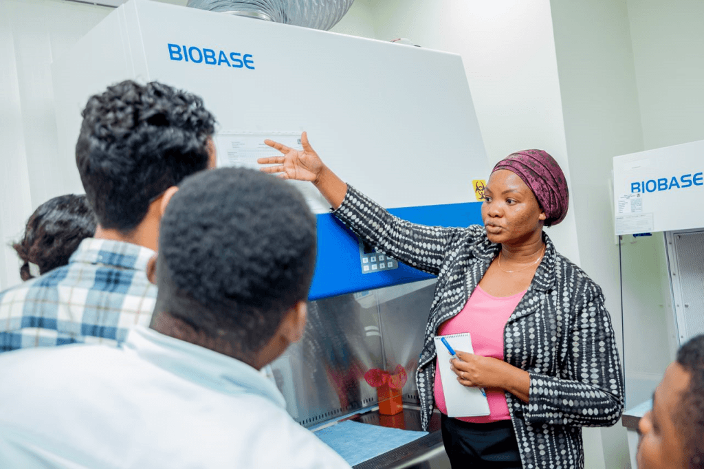 Course Instructor provides an overview of cabinet features during hands-on session during a biological safety cabinet certification training in Tanzania.