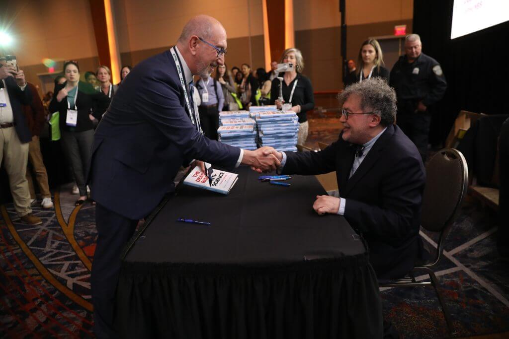 APHL CEO Scott Becker shakes hands with Dr. Peter Hotez, keynote speaker.