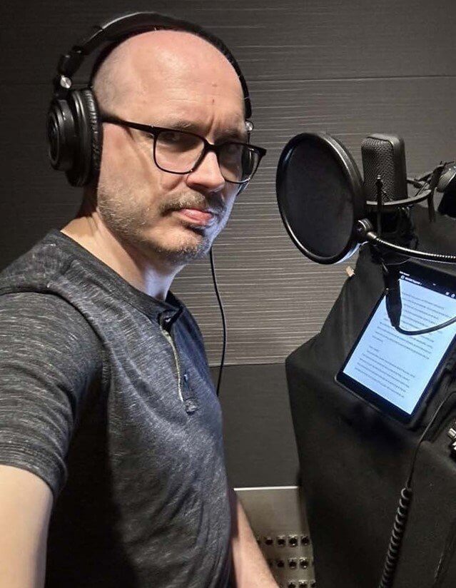Photo of Kevin Alexander in an audio recording booth