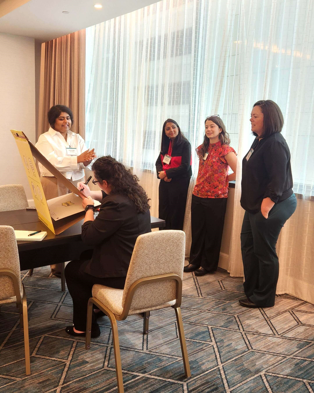 ELP Cohort 19 (Hybrid Modality) members collaborate on an information-gathering, brainstorming, and prioritizing activity during their in-person session.