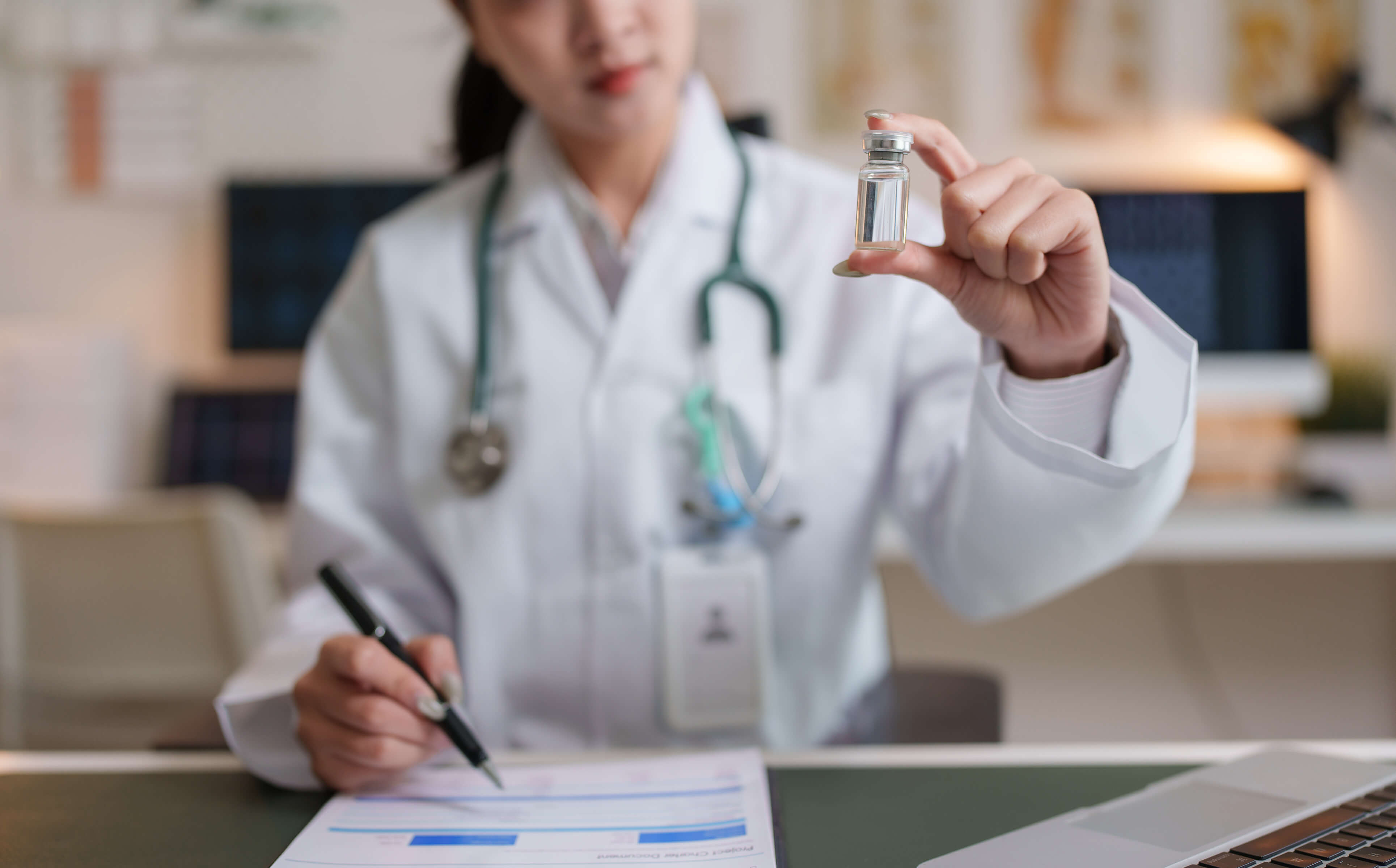Doctor holding vaccine vile