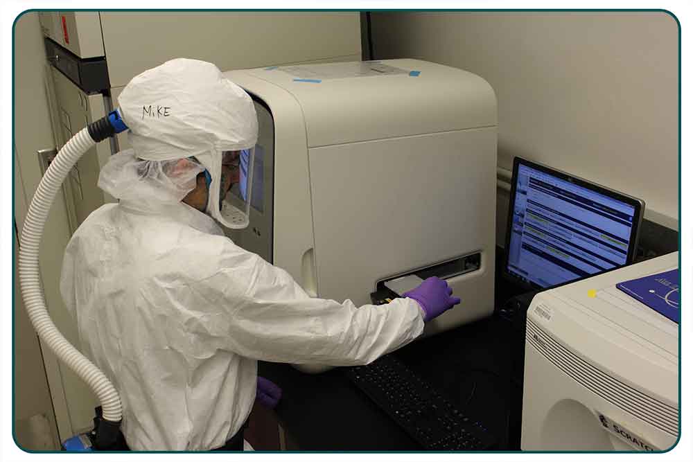 Michael J. Perry, DrPH, MEd, director of the Biodefense Laboratory at the Wadsworth Center, loads a polymerase chain reaction plate into a QuantStudio™ Dx instrument to prep for LRN-B testing.